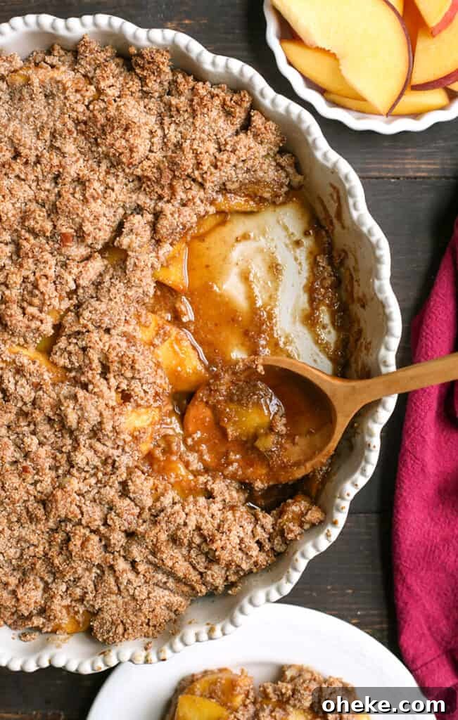 Paleo-Friendly Vegan Peach Crisp Recipe for Summer Desserts 4 paleo peach crisp with a spoonful taken out