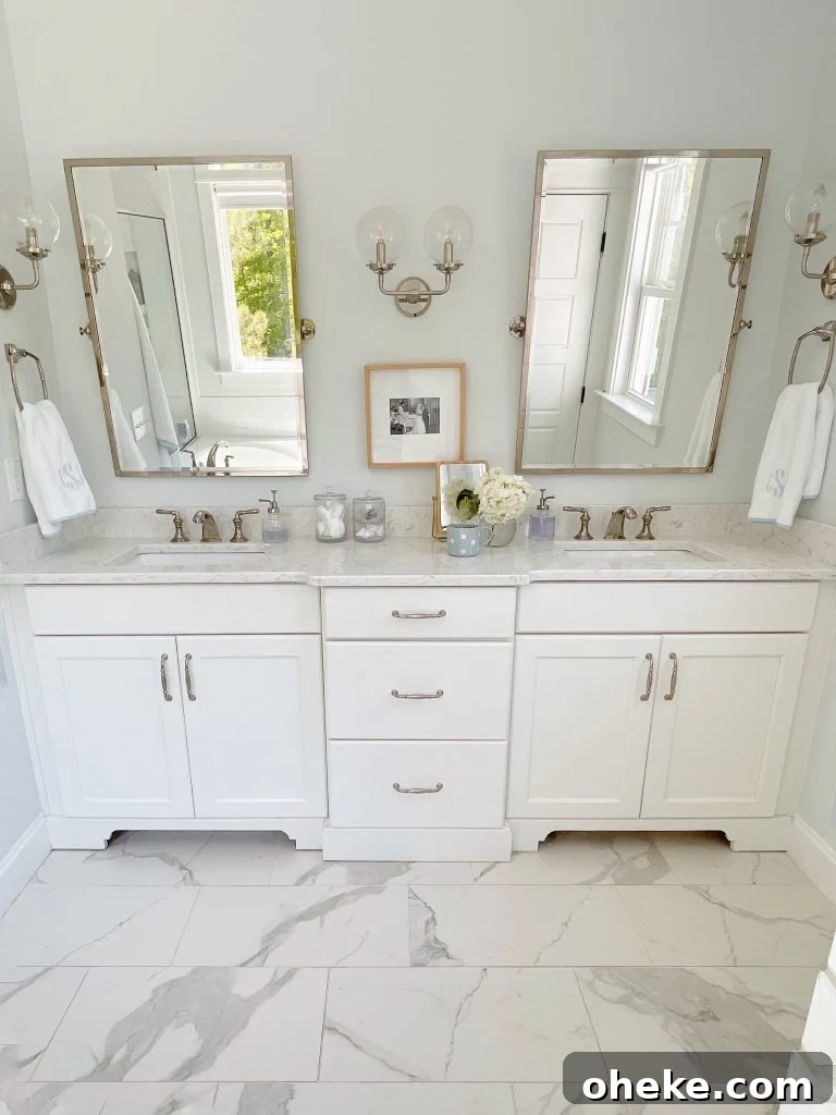 a white bathroom with big mirrors