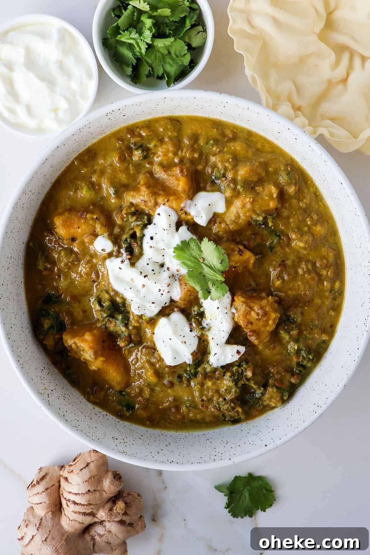 Curried Butternut Squash and Lentil Soup Recipe 2 Lentil and butternut squash soup in a bowl wiht yogurt drizzled on top.