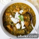 Butternut squash soup in a bowl with a spoon.