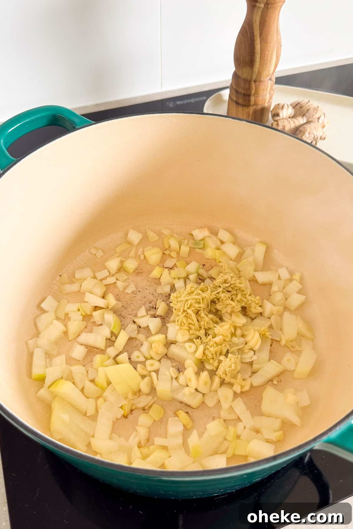 Curried Butternut Squash and Lentil Soup Recipe 5 Onion, garlic and ginger sautéing in a pot.