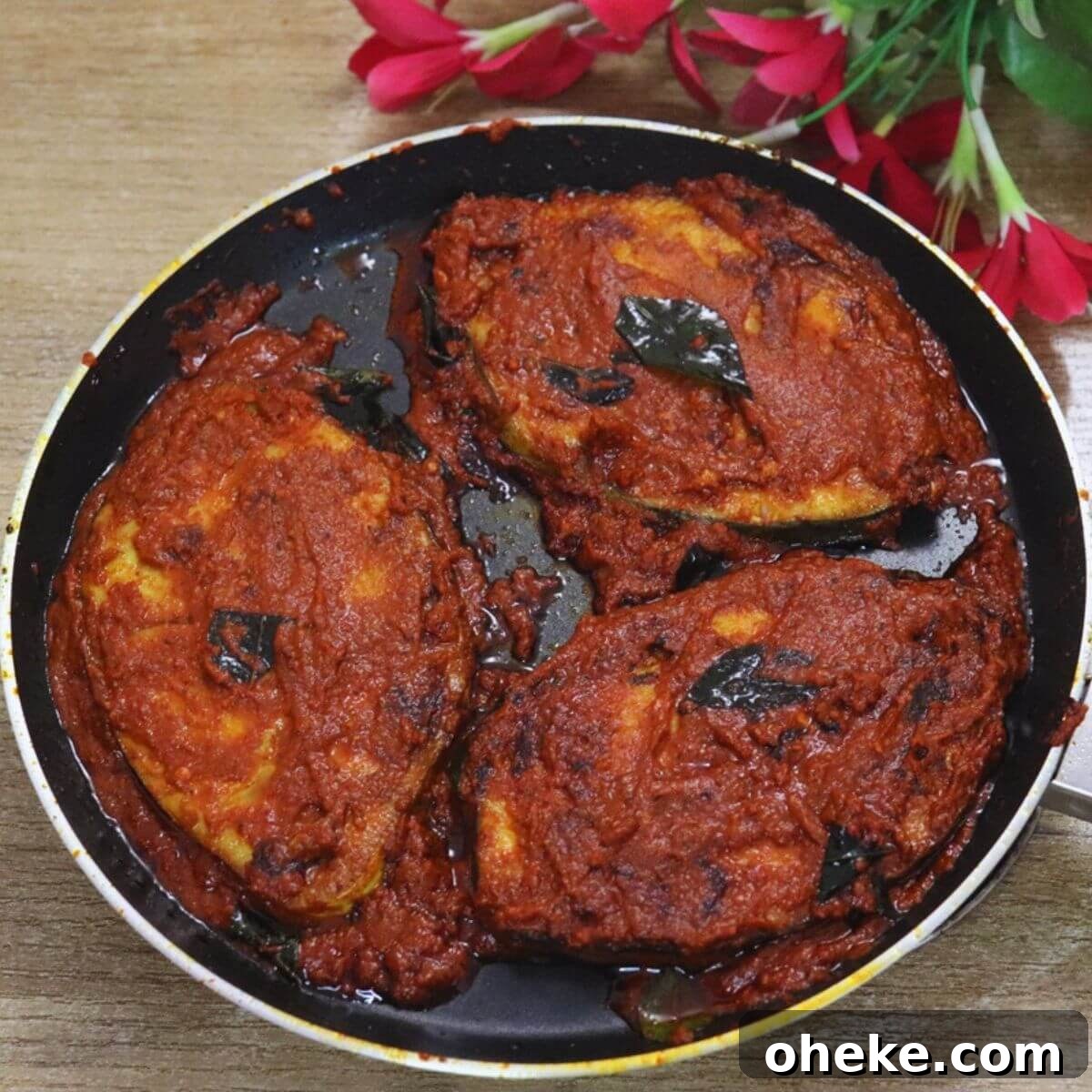 fish masala fry in a black colored pan.