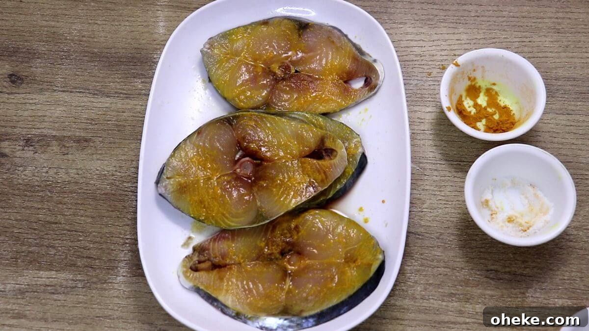 marinate fish with salt, turmeric and lemon juice for fish masala fry recipe.