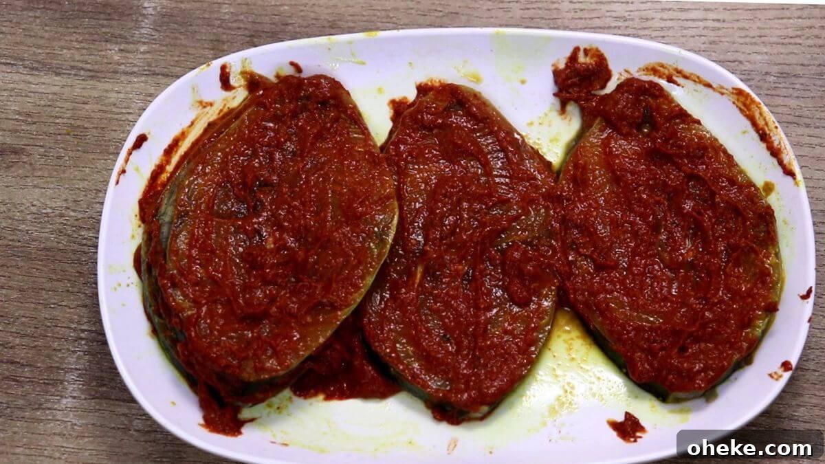 apply the homemade masala on the fish to make anjal fish fry.