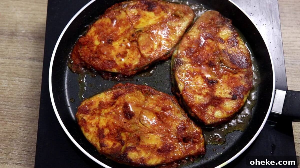 frying marinated fish on tawa.