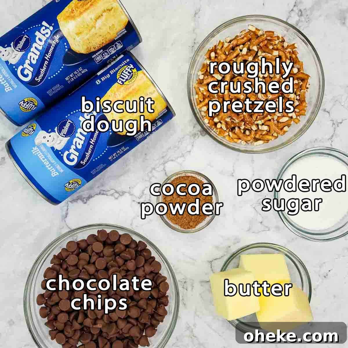 Chocolate Pretzel Biscuit Monkey Bread Recipe 3 Overhead shot of ingredients - biscuit dough, roughly crushed pretzels, chocolate chips, cocoa powder, powdered sugar, and butter.