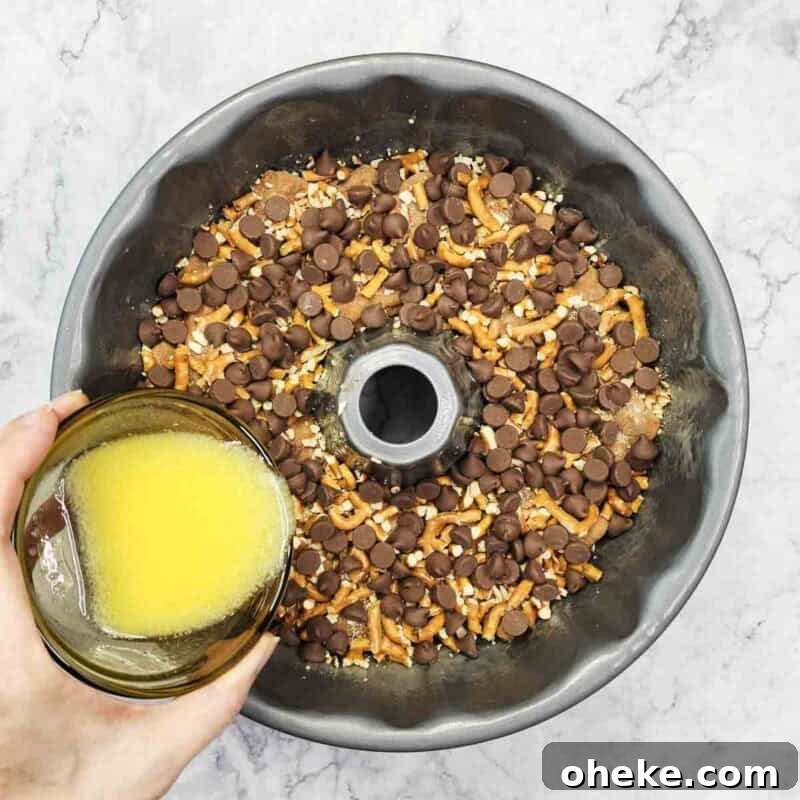 Chocolate Pretzel Biscuit Monkey Bread Recipe 8 Pour half the melted butter over the layer.
