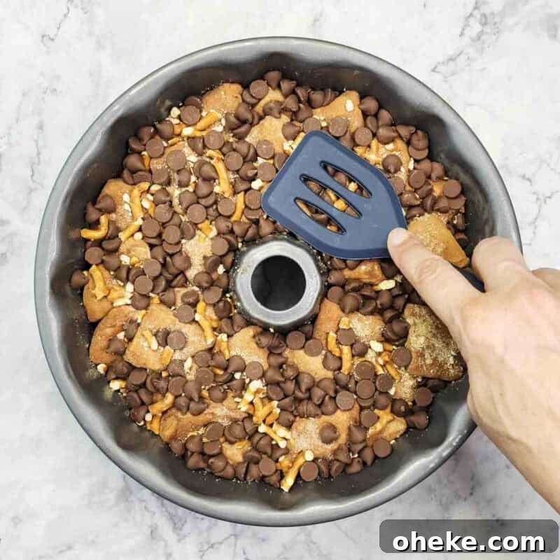 Chocolate Pretzel Biscuit Monkey Bread Recipe 9 Top with remaining biscuit pieces, pretzels, chips, and remaining butter; press down gently.