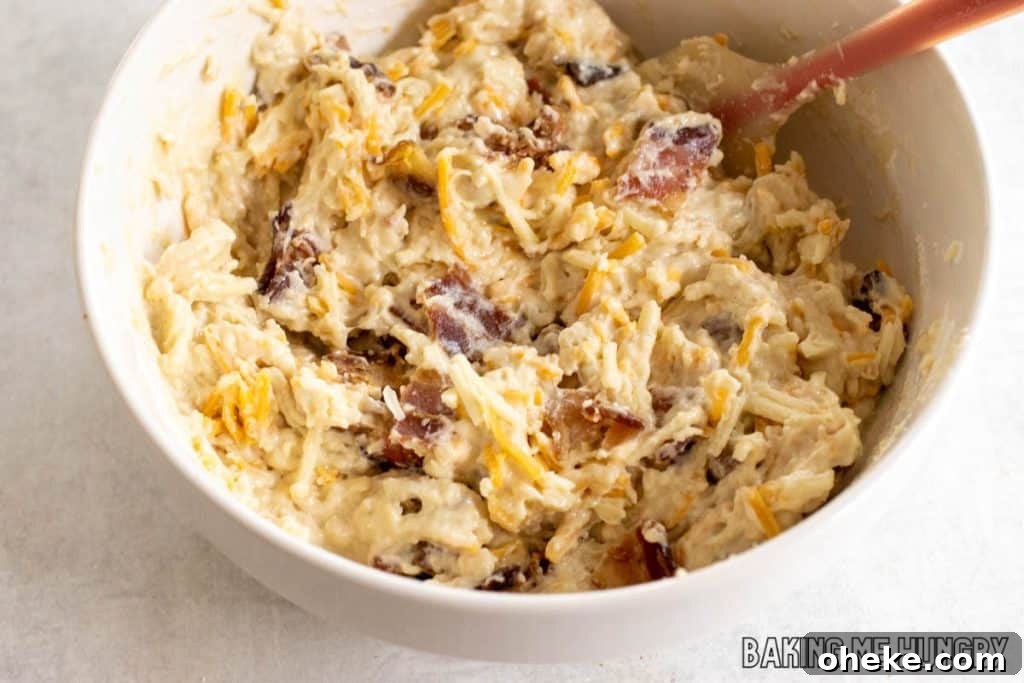 Savory Cheese & Bacon Breakfast Muffins That Impress 8 batter with mix-ins in bowl