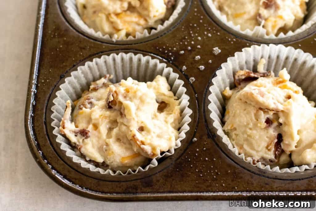 Savory Cheese & Bacon Breakfast Muffins That Impress 9 batter in paper liners
