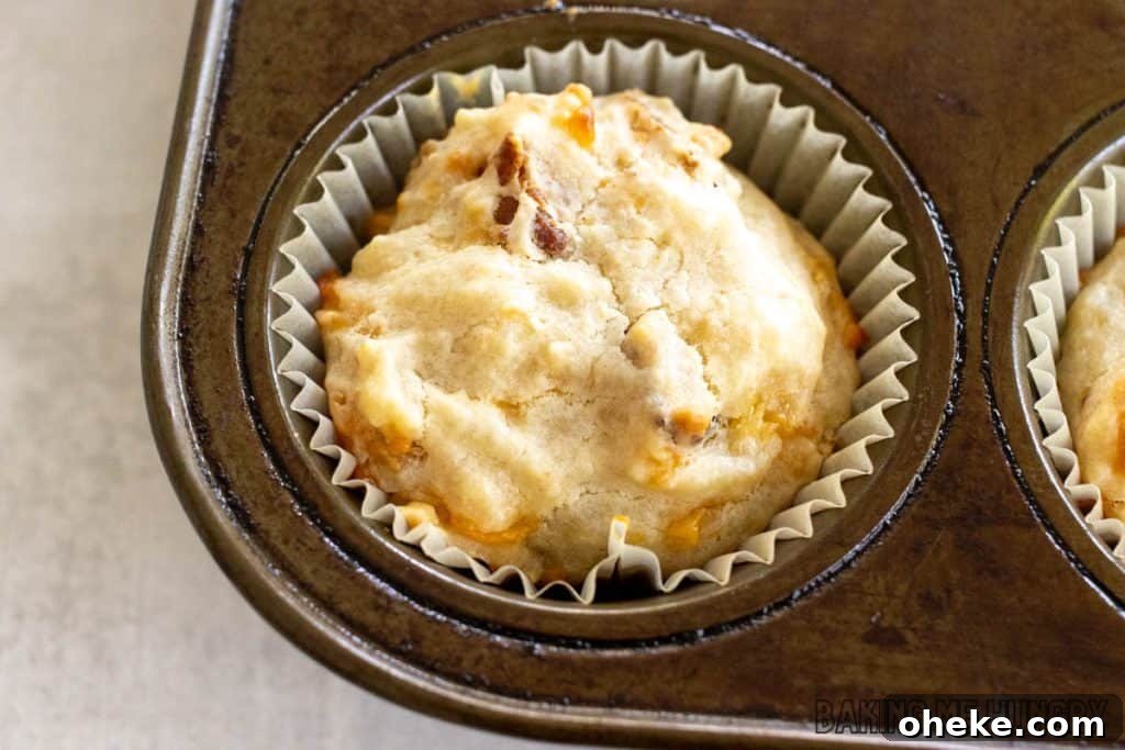 Savory Cheese & Bacon Breakfast Muffins That Impress 10 baked muffin in paper liner