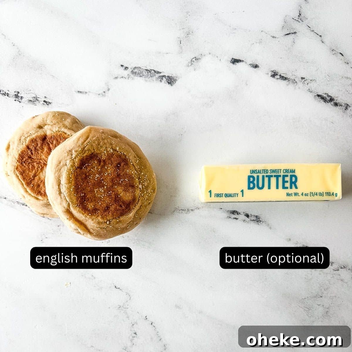 Labeled English muffins and butter sit on a white marble counter.