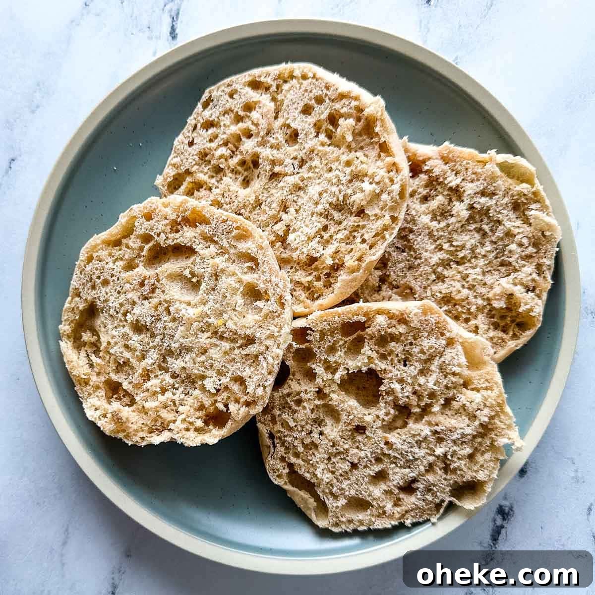 Split English muffins on a blue plate.