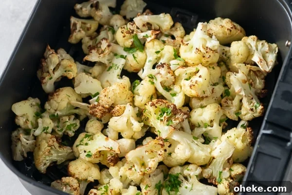 Cooked cauliflower in an air fryer basket