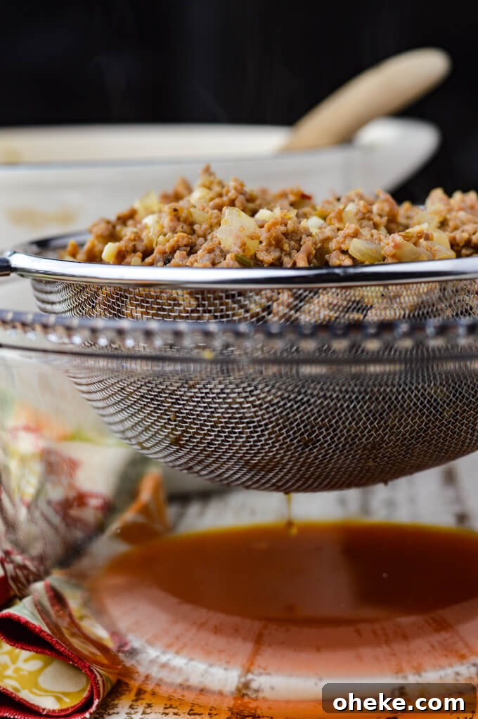 Slow-Cooker Lasagna Recipe for Tender, Cheesy Layers 5 Cooked chorizo draining in a wire mesh strainer that sits in a clear glass bowl.