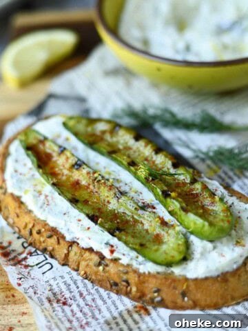 Grilled cucumber toast on a wood board.