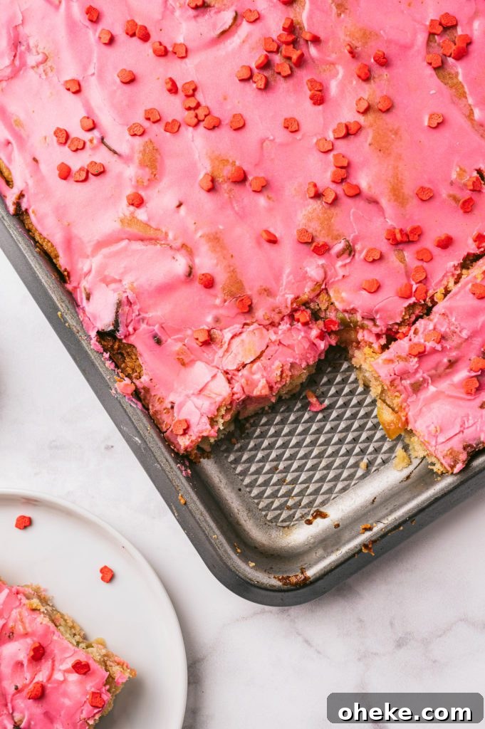 Bakery-Style Baked Apple Slices with Cinnamon Crumble 4 closeup vertical shot of apple slices with pink icing and valentine's sprinkles