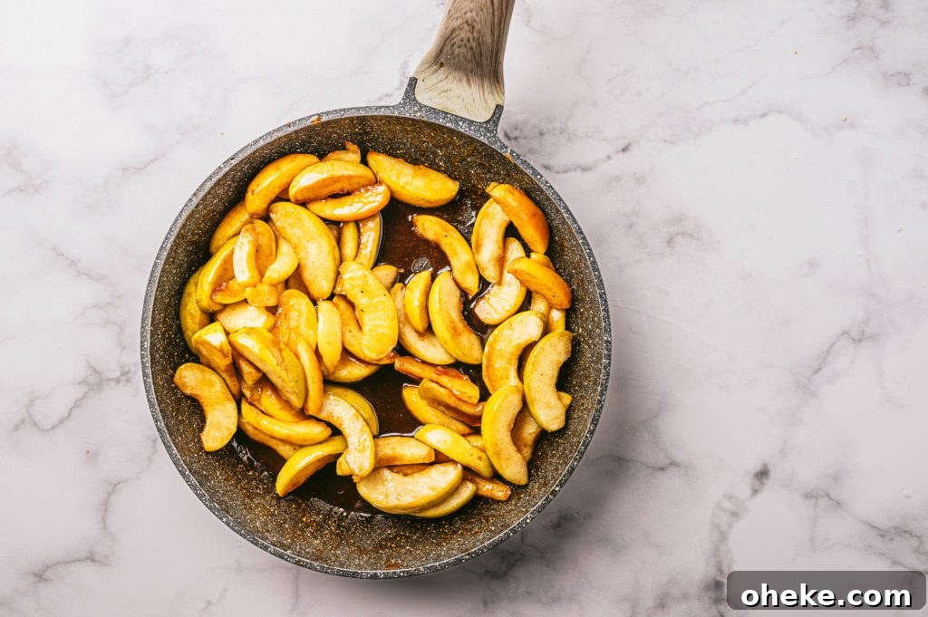 Bakery-Style Baked Apple Slices with Cinnamon Crumble 6 sliced apples in saucepan