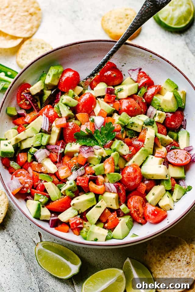 This avocado salsa is a next-level Cinco de Mayo recipe! It's creamy, chunky, and 100% addictive. It's like a flavor party in one bowl! avocado salsa served in a salad bowl