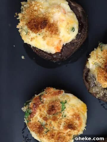 Shrimp stuffed mushrooms being served on a platter.