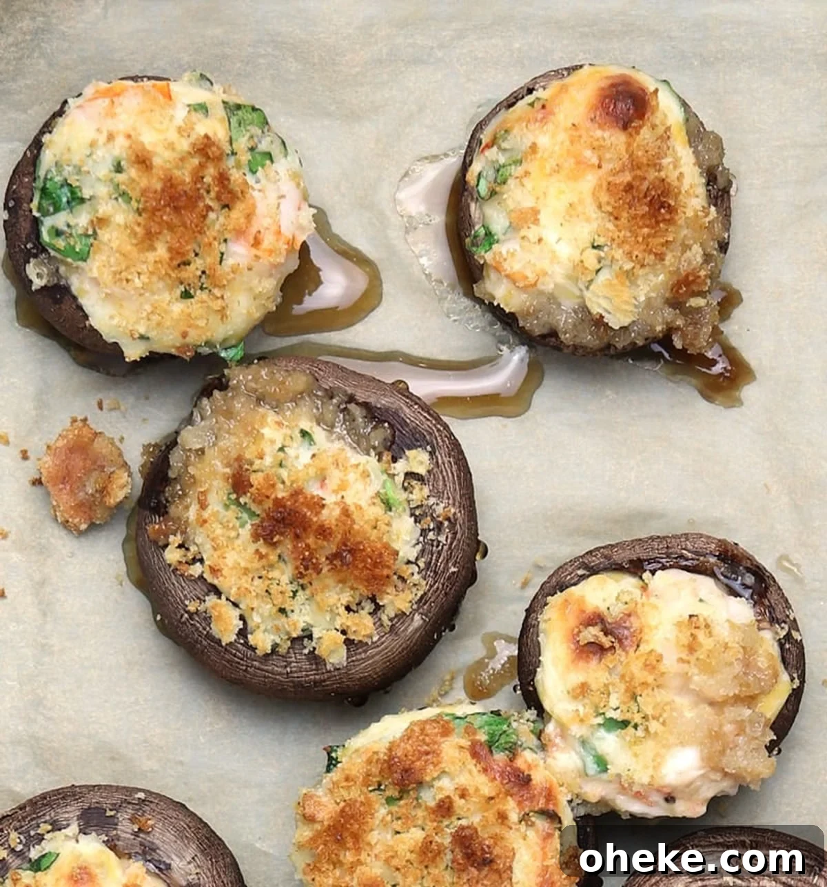 Stuffed shrimp mushrooms on a backing sheet.