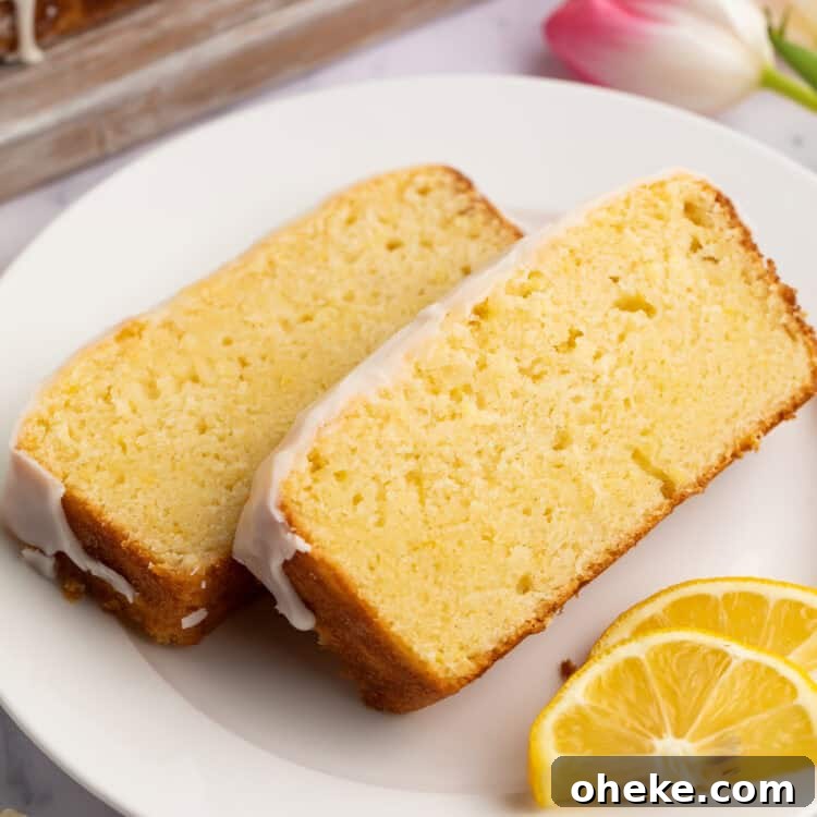 Ultimate Gluten-Free Lemon Cake Recipe — Moist & Zesty 4 Two slices of gluten-free iced lemon pound cake on a plate with lemon slices.