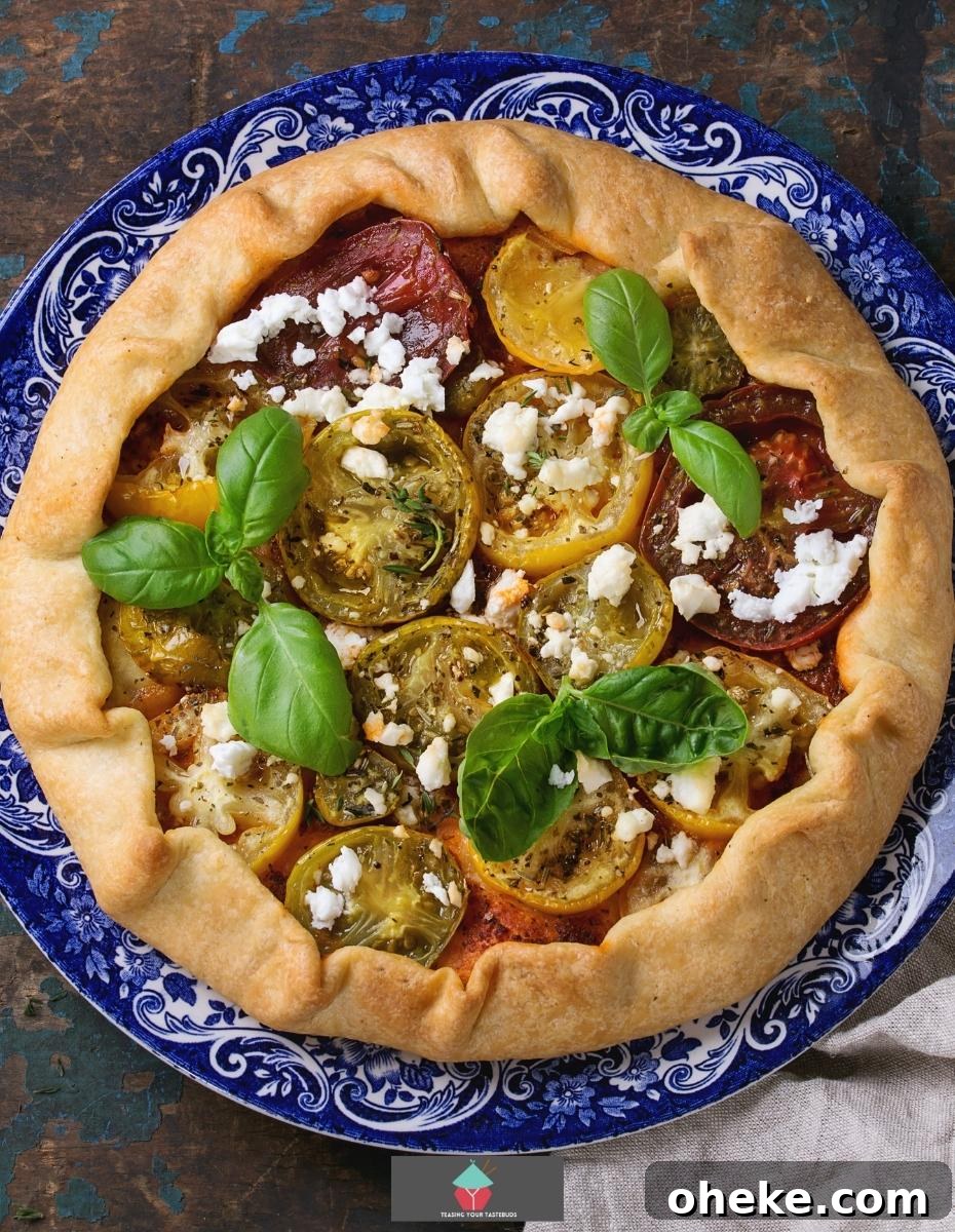 Spinach and Feta Galette, a delicious open pastry savoury pie filled with Greek feta cheese creamy spinach and tomatoes, then baked until set. Great served warm or chilled.
