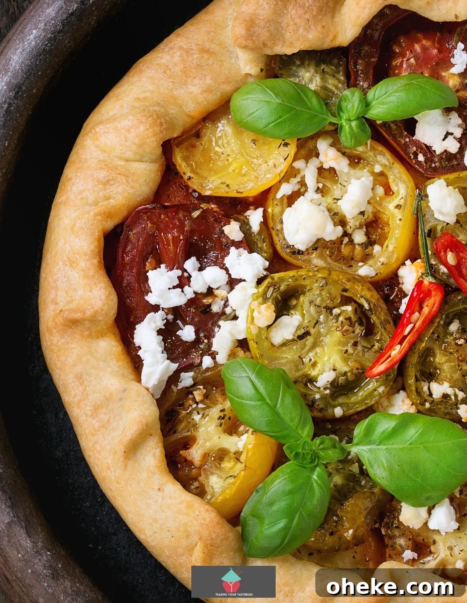 Spinach and Feta Galette, a delicious open pastry savoury pie filled with Greek feta cheese creamy spinach and tomatoes, then baked until set. Great served warm or chilled.
