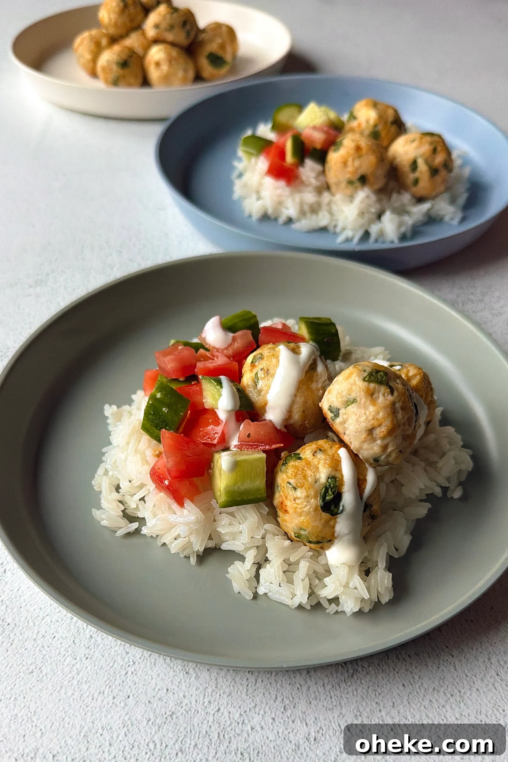Greek-Style Chicken and Feta Meatballs with Lemon Herb Sauce 6 Chicken feta meatballs served over rice.