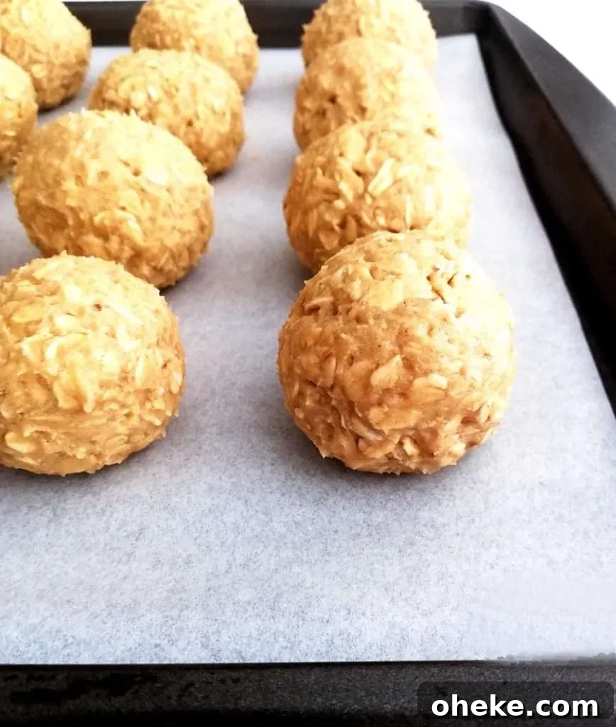oatmeal cookie dough balls on baking sheet side view