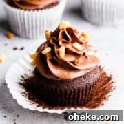 45 degree angle super close up at a chocolate cupcake topped with chocolate buttercream