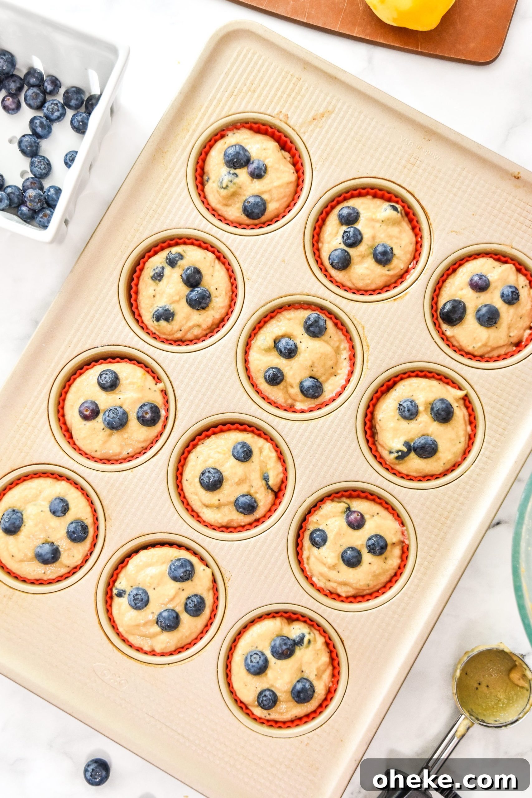 blueberry lemon pancake mix muffin batter in the muffin tin before baking.