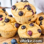 stacked muffins on a cutting board.
