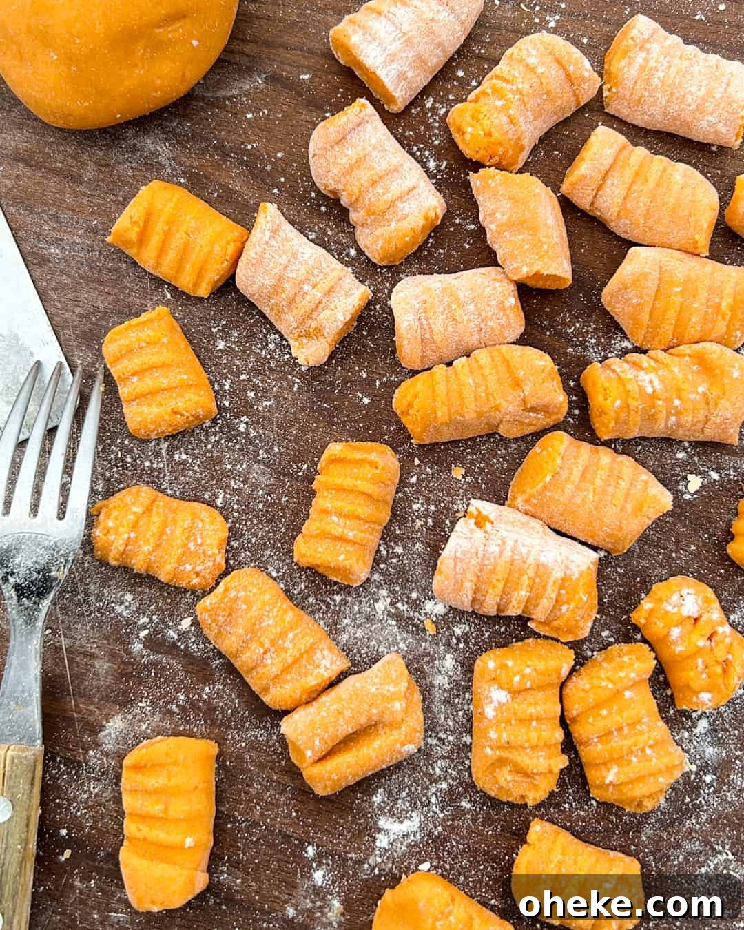 Sweet Potato Gnocchi with Garlic Mushrooms (Gluten-Free) 6 Sweet potato gnocchi being formed with the tines of a fork