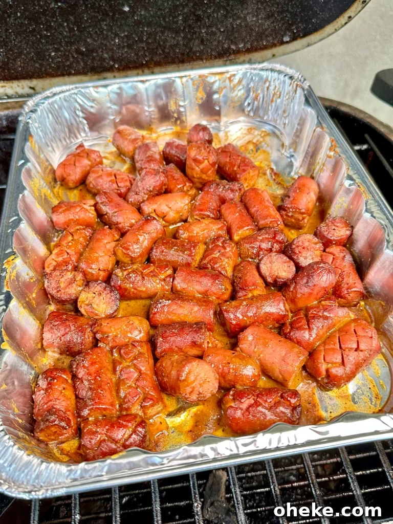Carolina Gold BBQ Burnt Ends Made from Hot Dogs 7 hot dogs in a pan with the carolina sauce on them