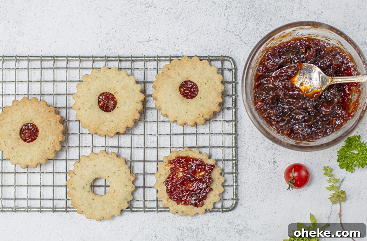 Tomato Jam Linzer Thins: Savory Cheese Shortbread Cookies 3 Savory Cheese Linzer Thins sandwiched with Tomato Jam on a vintage wire rack