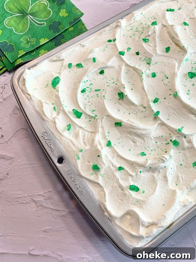 Buttermilk Lime Poke Cake Recipe — Moist Citrus Dessert 4 A Buttermilk Lime Poke Cake in a cake pan.