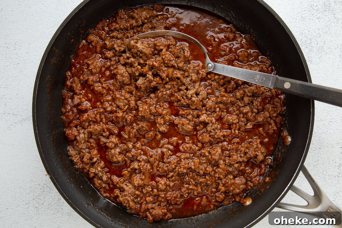 ground beef in a tomato based sauce in a large skillet.