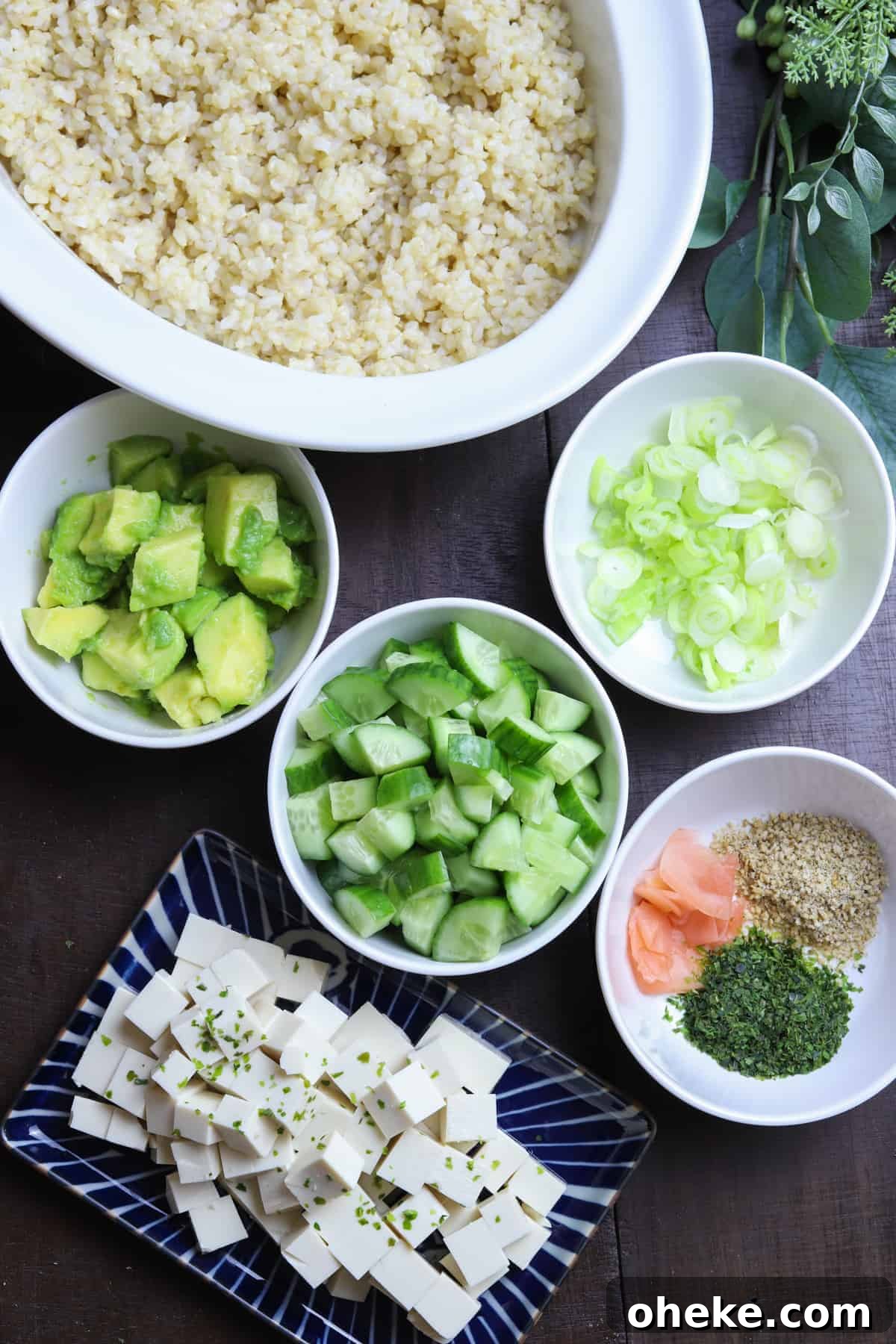 photo of ingredients for vegan sushi bowl in white bowls on a dark wood background