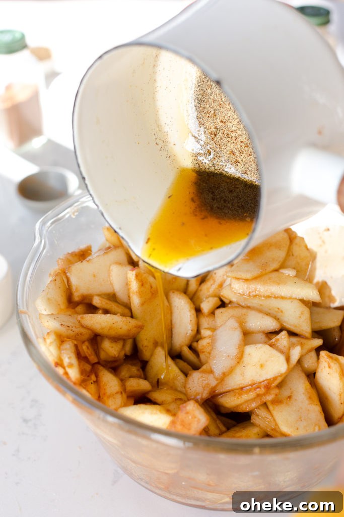 pouring vanilla browned butter over pie filling