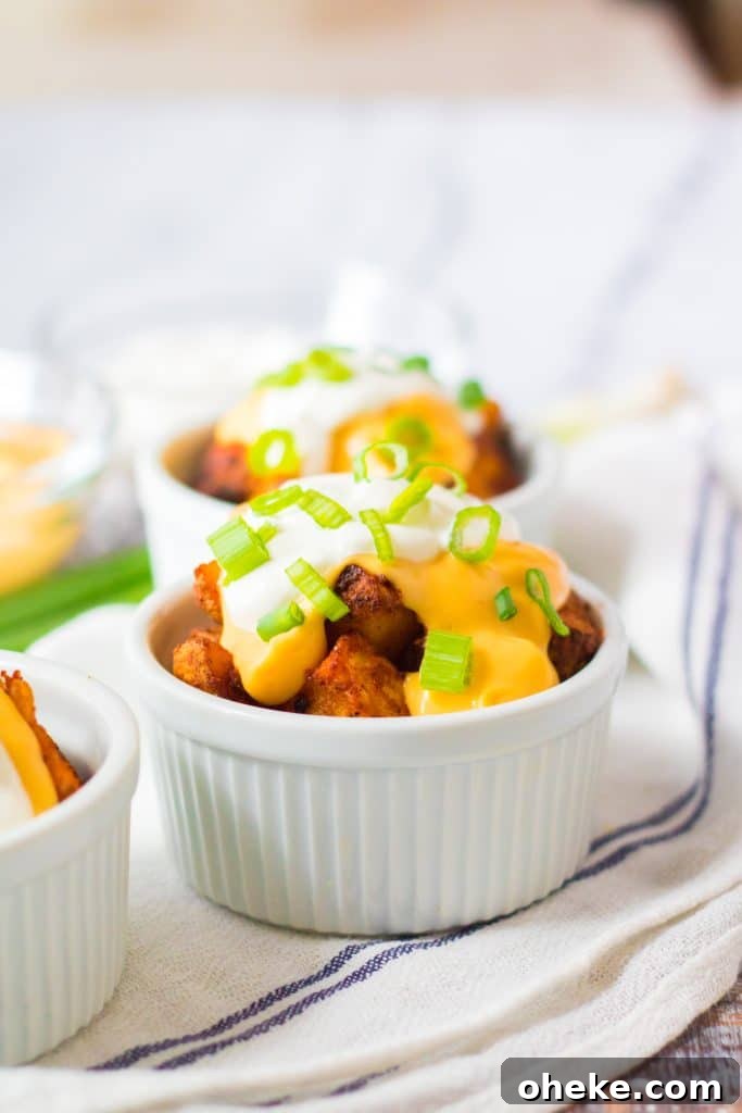 Air Fryer Cheesy Fiesta Potatoes — Taco Bell Copycat Recipe 9 copycat taco bell cheesy fiesta potatoes in a white ramekin