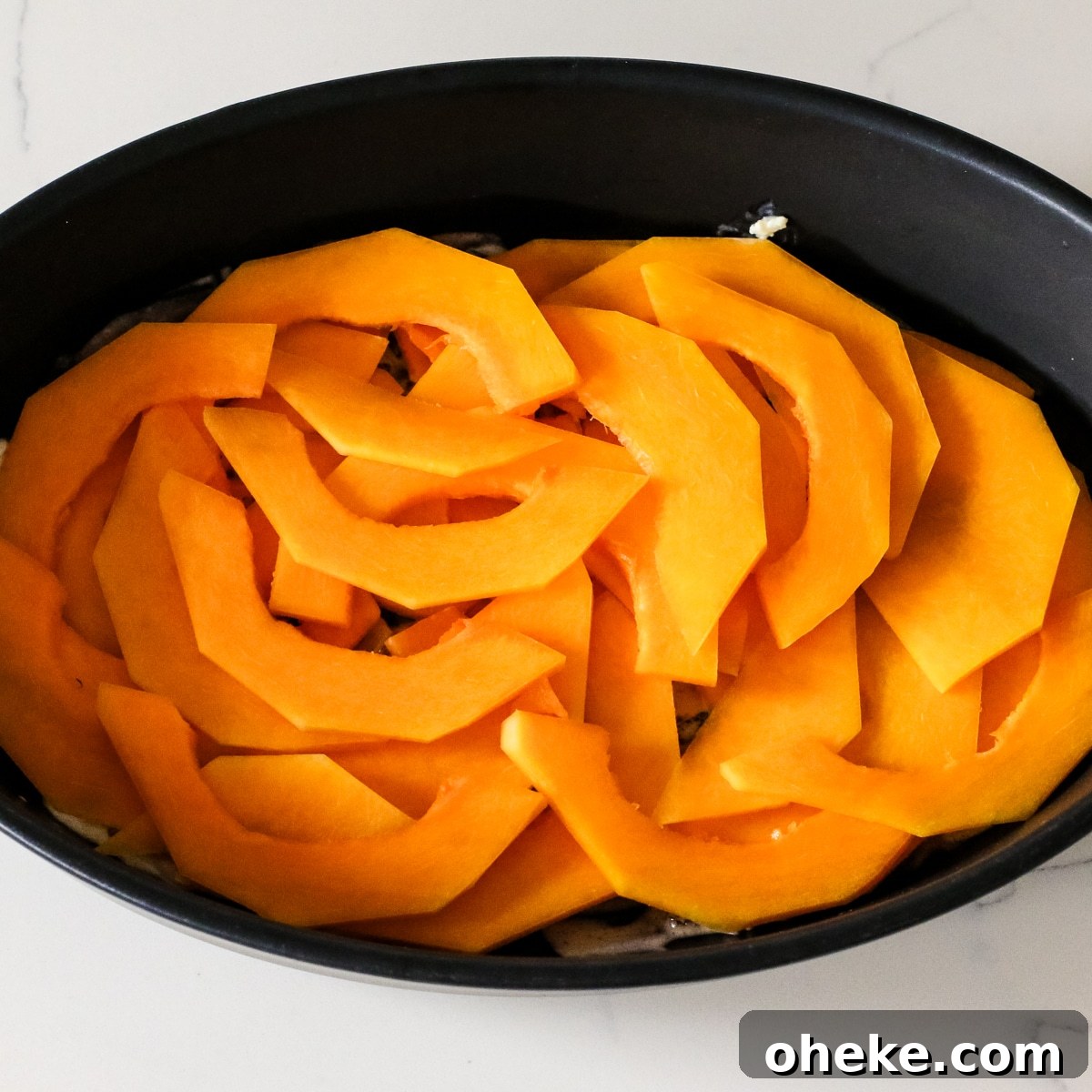 sliced squash in a baking dish.