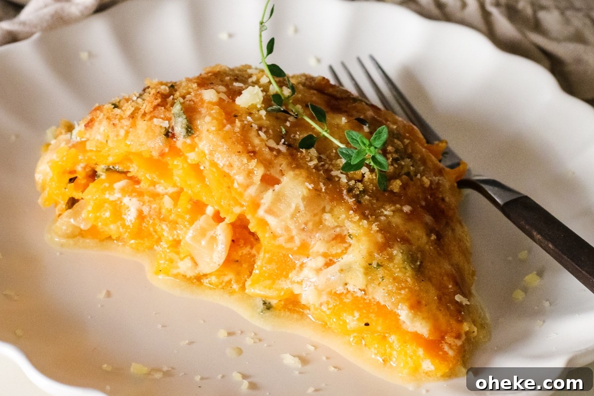 cut slice of butternut squash gratin on a plate with a fork.