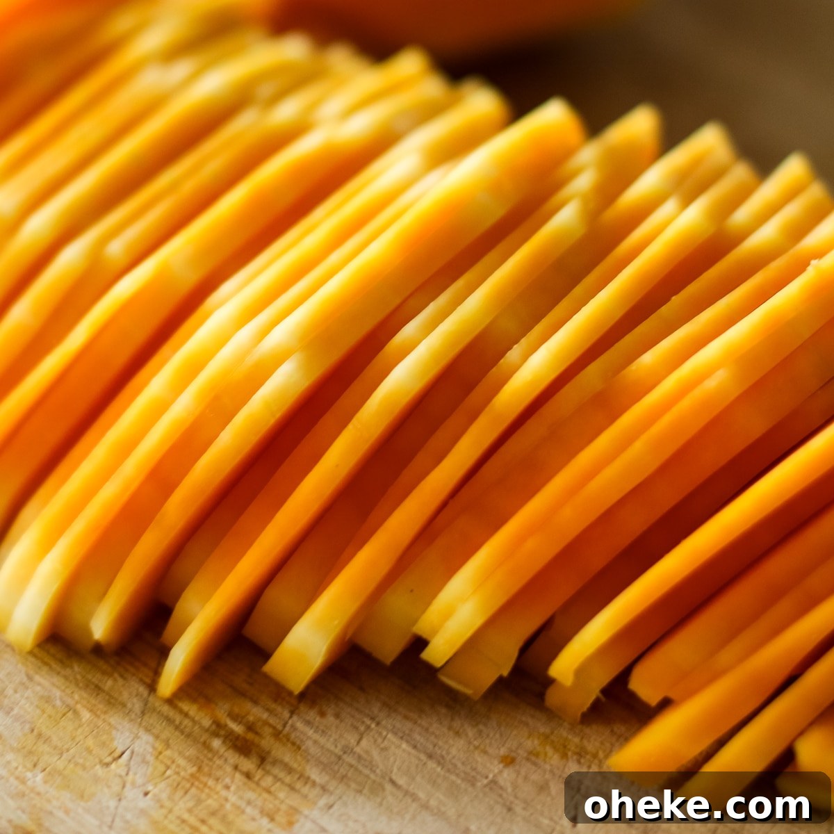 Squash sliced on a wood cutting board.