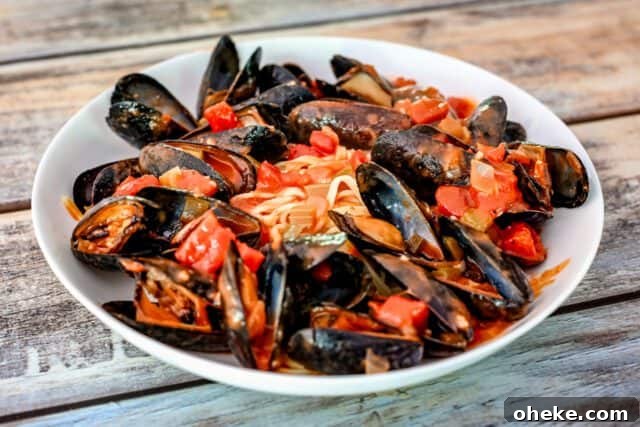 A bowl of Creole style mussels with linguine.