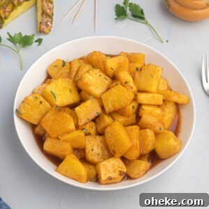 Juicy pineapple glazed with honey and bbq sauce, served in a white bowl.