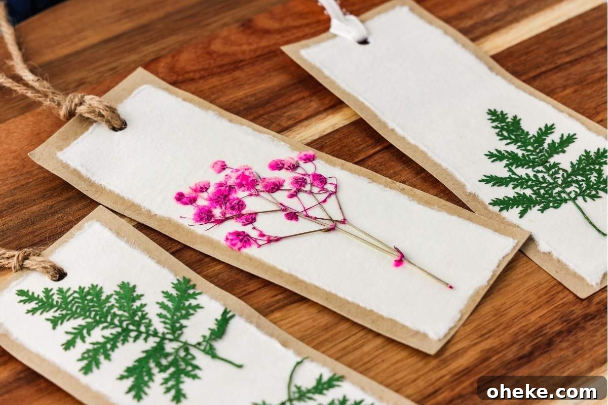 DIY Pressed Flower Bookmarks: Step-by-Step Craft Tutorial 2 A trio of pressed flower bookmarks crafted in a DIY fashion showcases delicate dried flowers and greenery, elegantly presented on a wooden surface.
