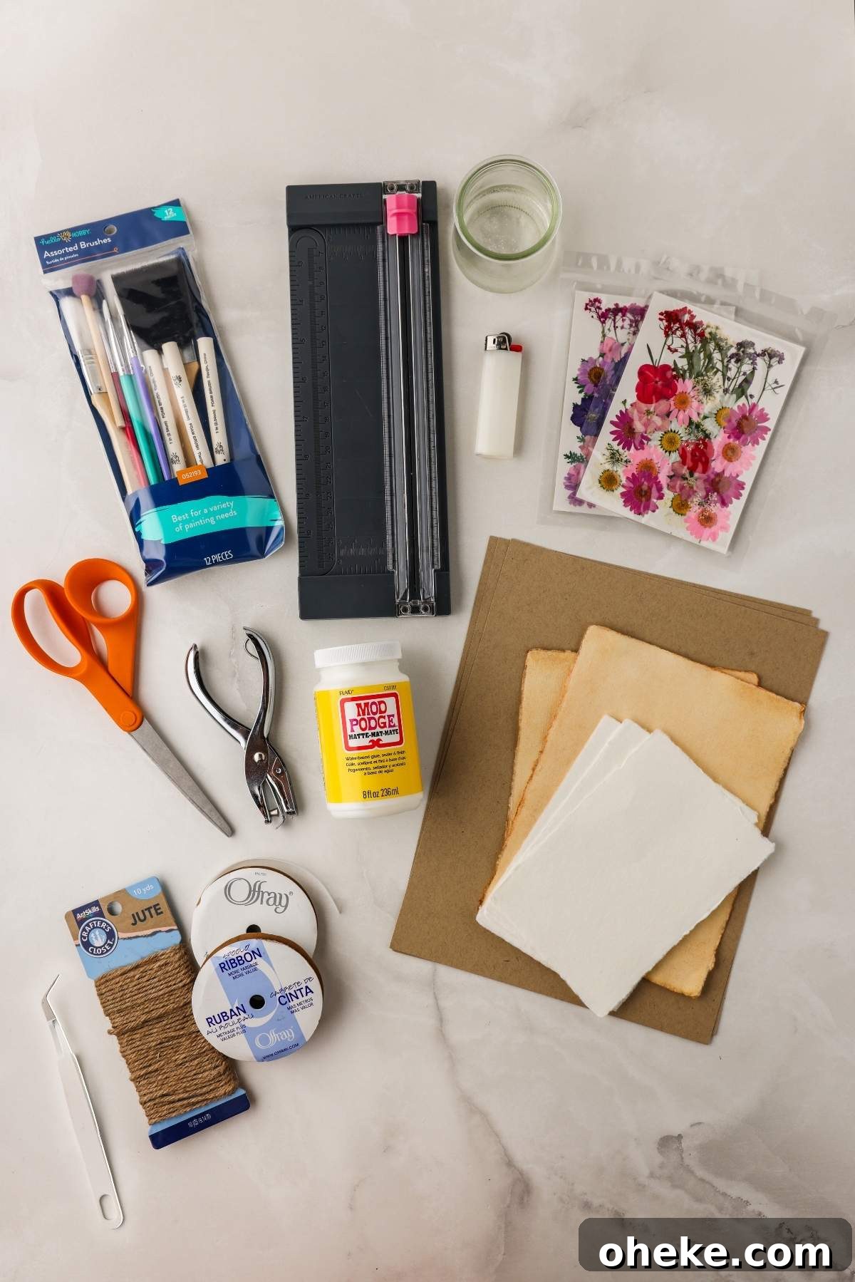 DIY Pressed Flower Bookmarks: Step-by-Step Craft Tutorial 11 Craft supplies including scissors, a hole punch, glue, a cutting tool, markers, string, paper, and a lighter are arranged on a table for creating pressed flower bookmarks in this fun DIY project.