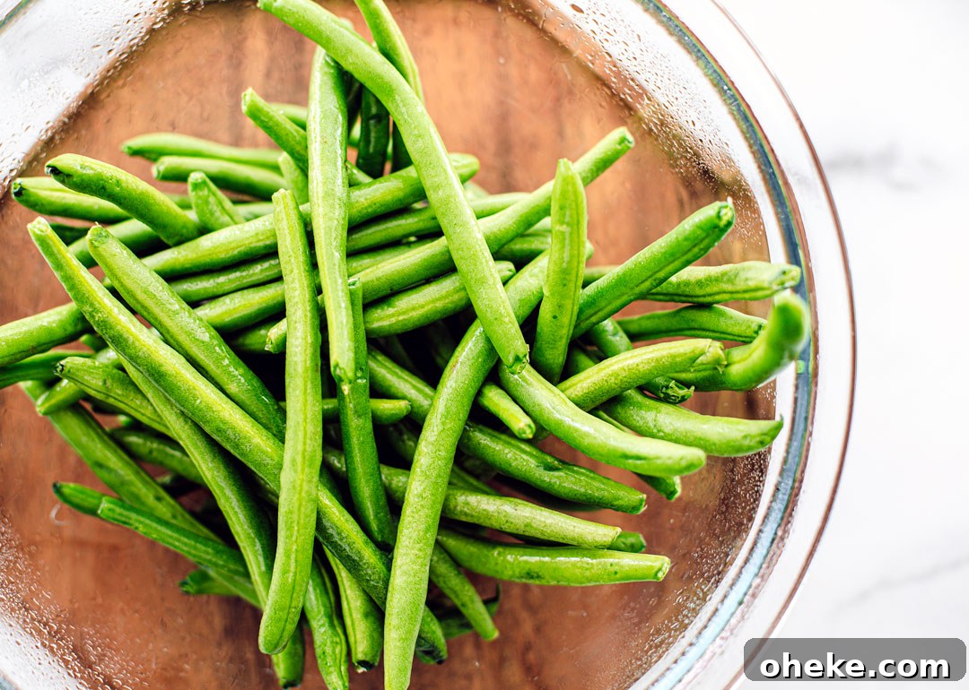 Glass bowl full of fresh green beans.