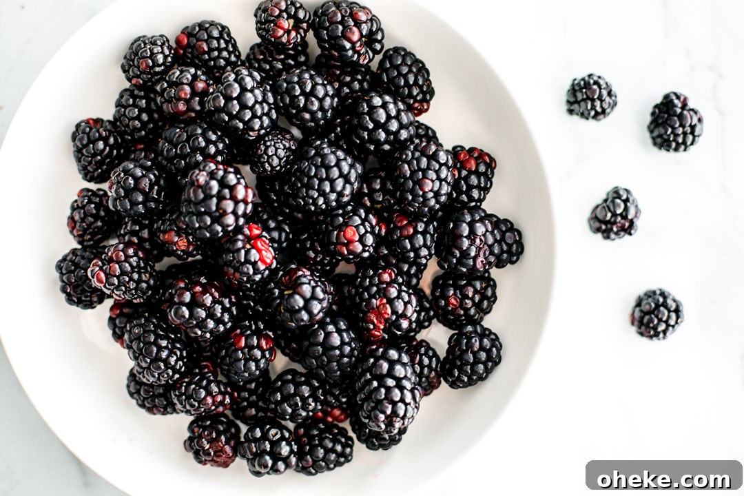 Big white bowl of blackberries.